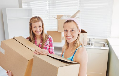 Professional movers unloading household items at a Strawberry Hill property