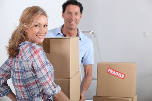 Movers handling desks and IT equipment during an office move